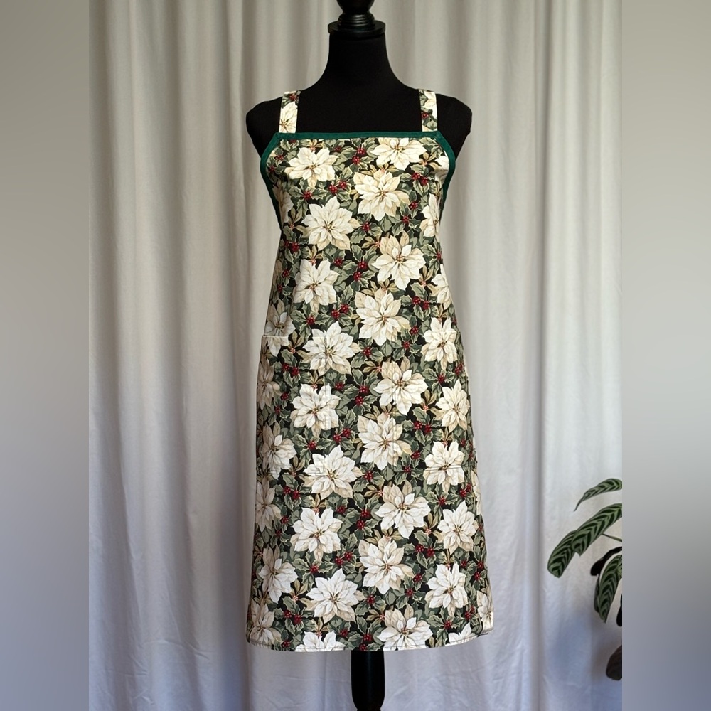 Christmas Apron. White poinsettias and holly on a black background. One size.
